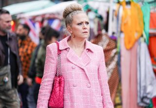 Linda Carter looking scared in a pink coat in EastEnders 