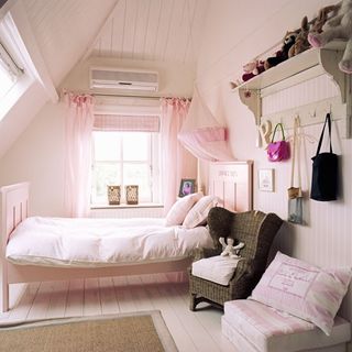 bedroom with pink wall and air conditioner