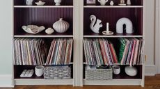 close up of ikea shelving unit with records styled on bottom shelf, and decor styled on shelves above