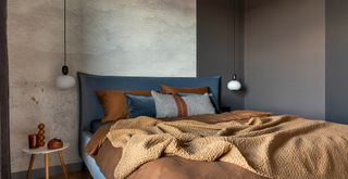 brown bedroom paint color with abstract cloud wallpaper behind the headboard