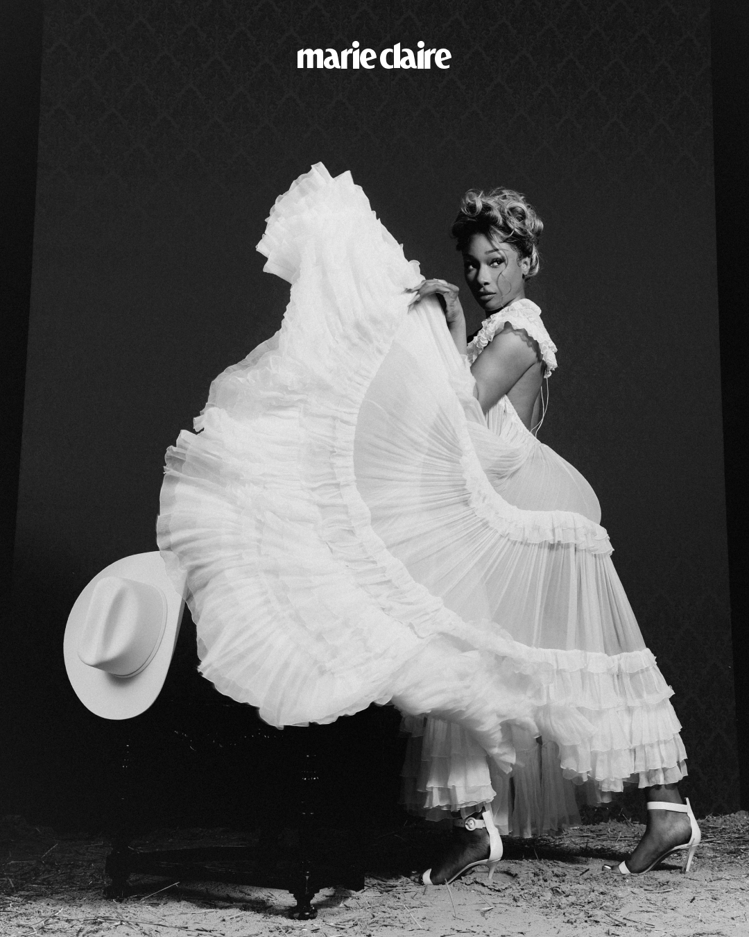 Megan Thee Stallion poses in a frilly white dress for Marie Claire