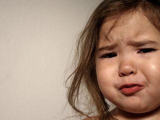 Sad crying toddler girl.
