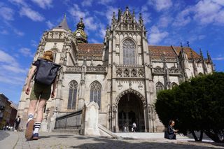 Image shows Anna wearing the Ortlieb Vario PS pannier backpack while sightseeing in Kosice.