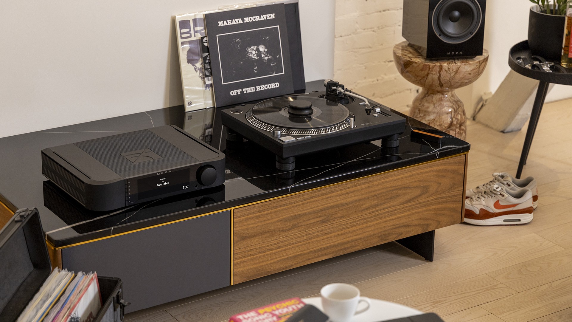 Moon 341 amplifier in black on a hi-fi rack