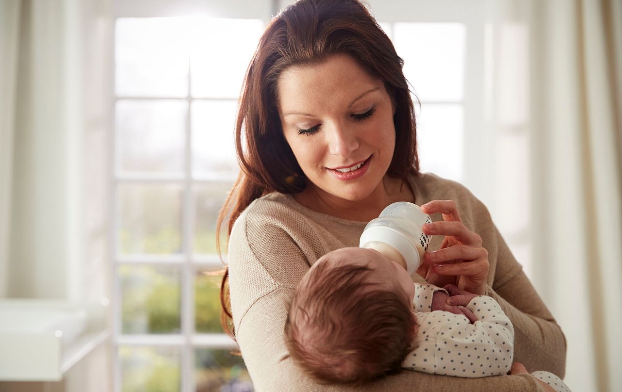 mother bottle feeding baby