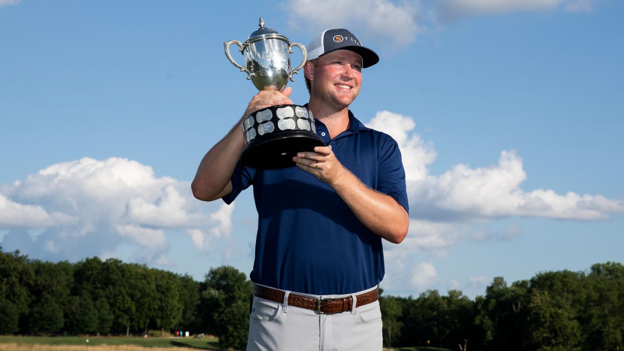 Trey Mullinax holding a trophy after winning the 2022 Barbasol Championship