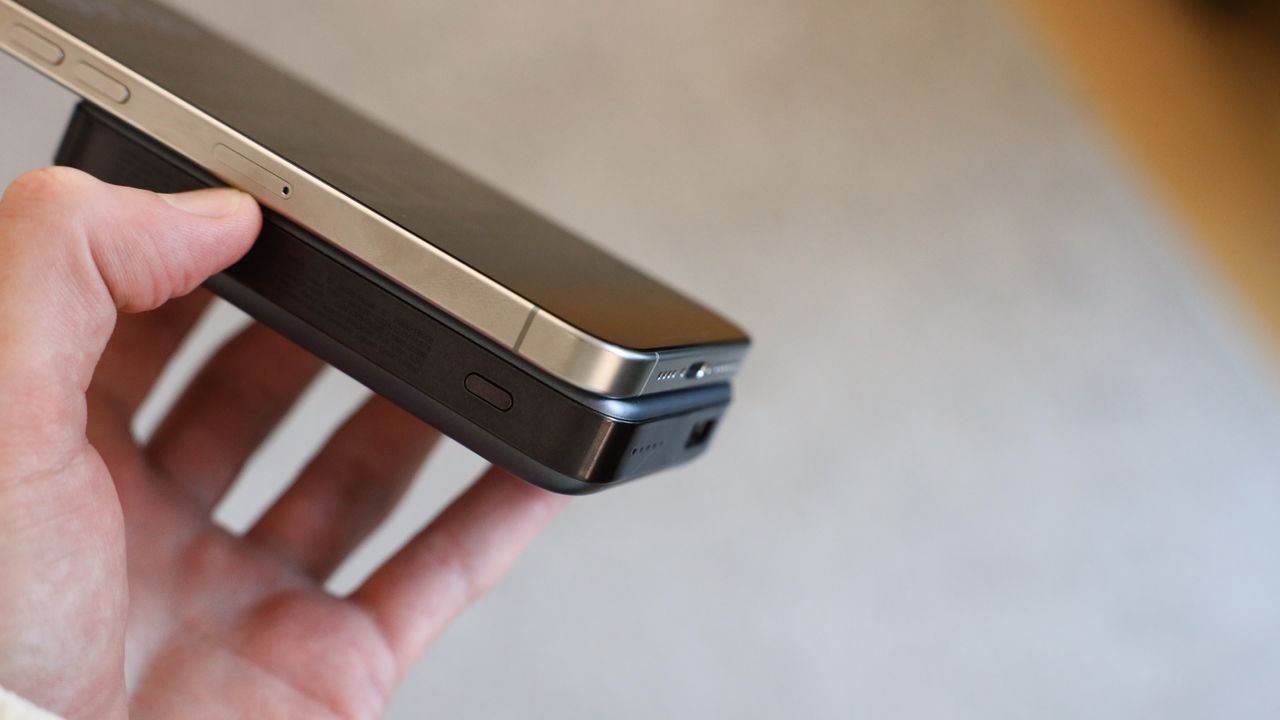 UGREEN MagSafe 10,000mAh attached to an iPhone 15 Pro Max and held in a hand