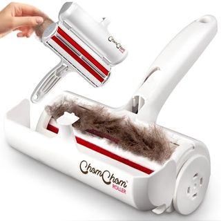 An open white plastic Chom Chom Roller Pet Hair Remover and Reusable Lint Roller filled with pet hair