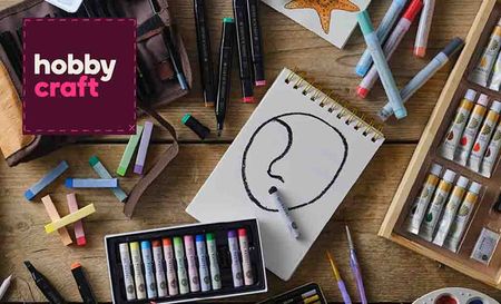 hobbycraft logo top left with a picture of art supplies on a desk with sketch of half drawn line face