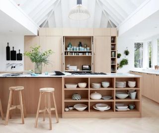 Kitchen island with open shelving for displaying decor and pretty tableware