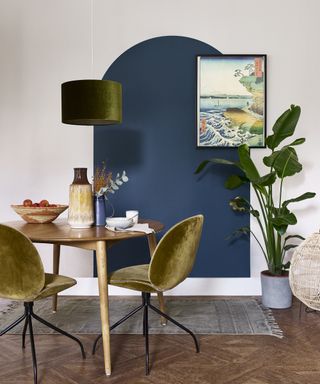A dining room wall idea with a painted navy blue arch