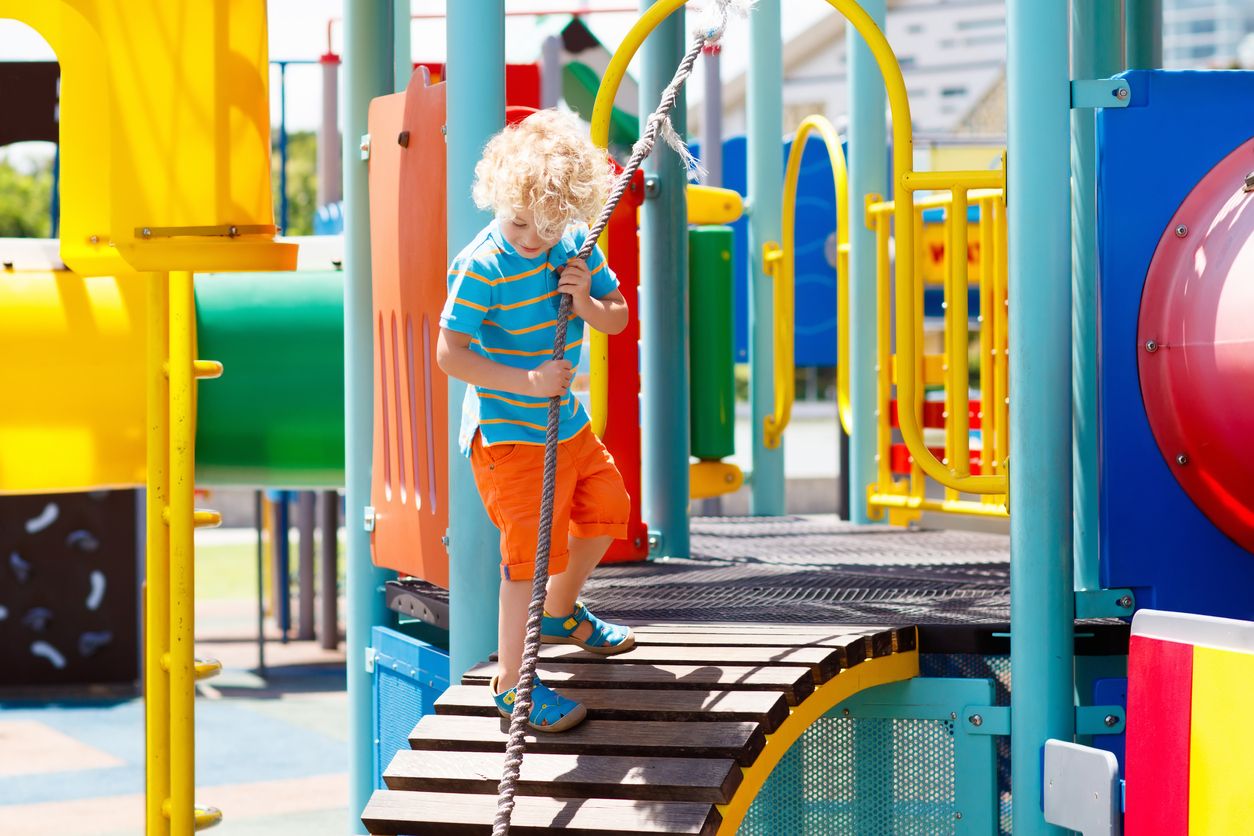 A child on playground equipment.