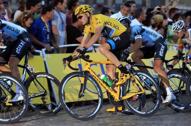 Chris Froome (Sky) in yellow rounds a bend on Stage 21 of the Tour de France