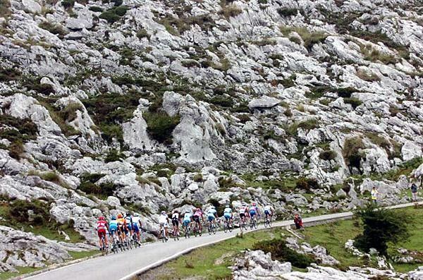 High rock walls surround a group on its way to Lagos de Covadonga