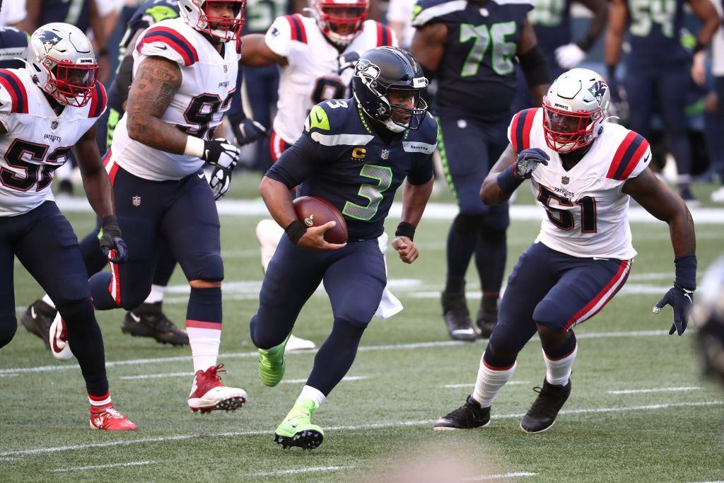 Russell Wilson #3 of the Seattle Seahawks runs with the ball against Ja&amp;#039;Whaun Bentley #51 of the New England Patriots in the first quarter at CenturyLink Field on September 20, 2020 in Seattl