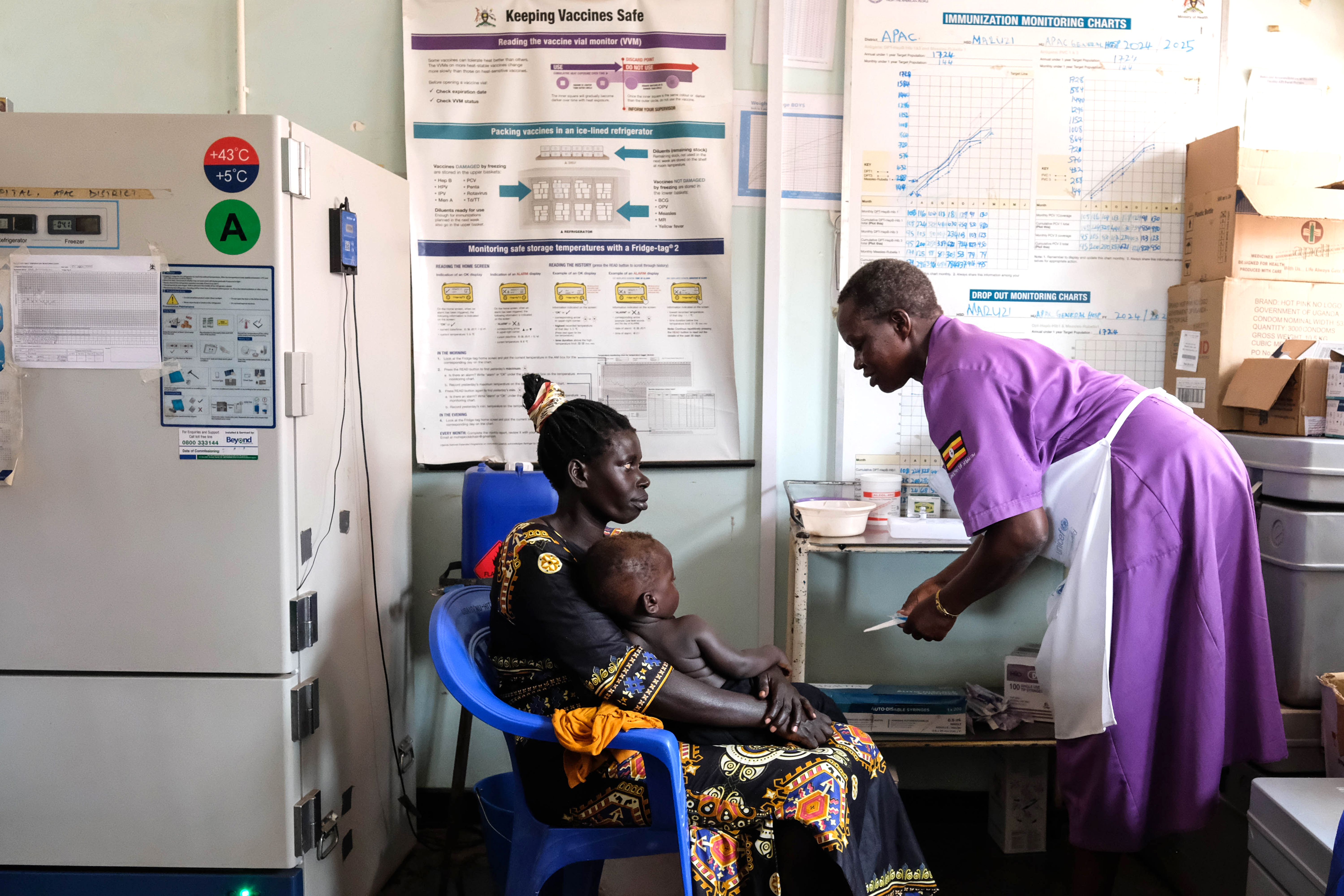 A nurse assistant prepares a malaria vaccine at Uganda's Apac General Hospital on April 8, 2025.
