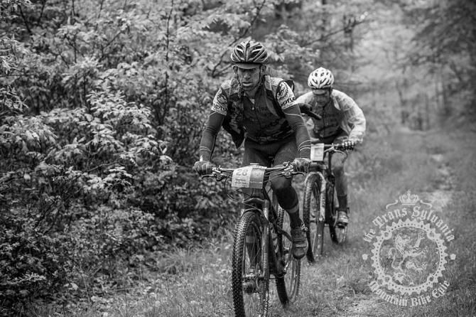 Brian Matter and Justin Lindine pushing through the wet grass on the last climb of stage 3.