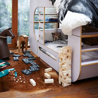 kids bedroom with wooden flooring and bed