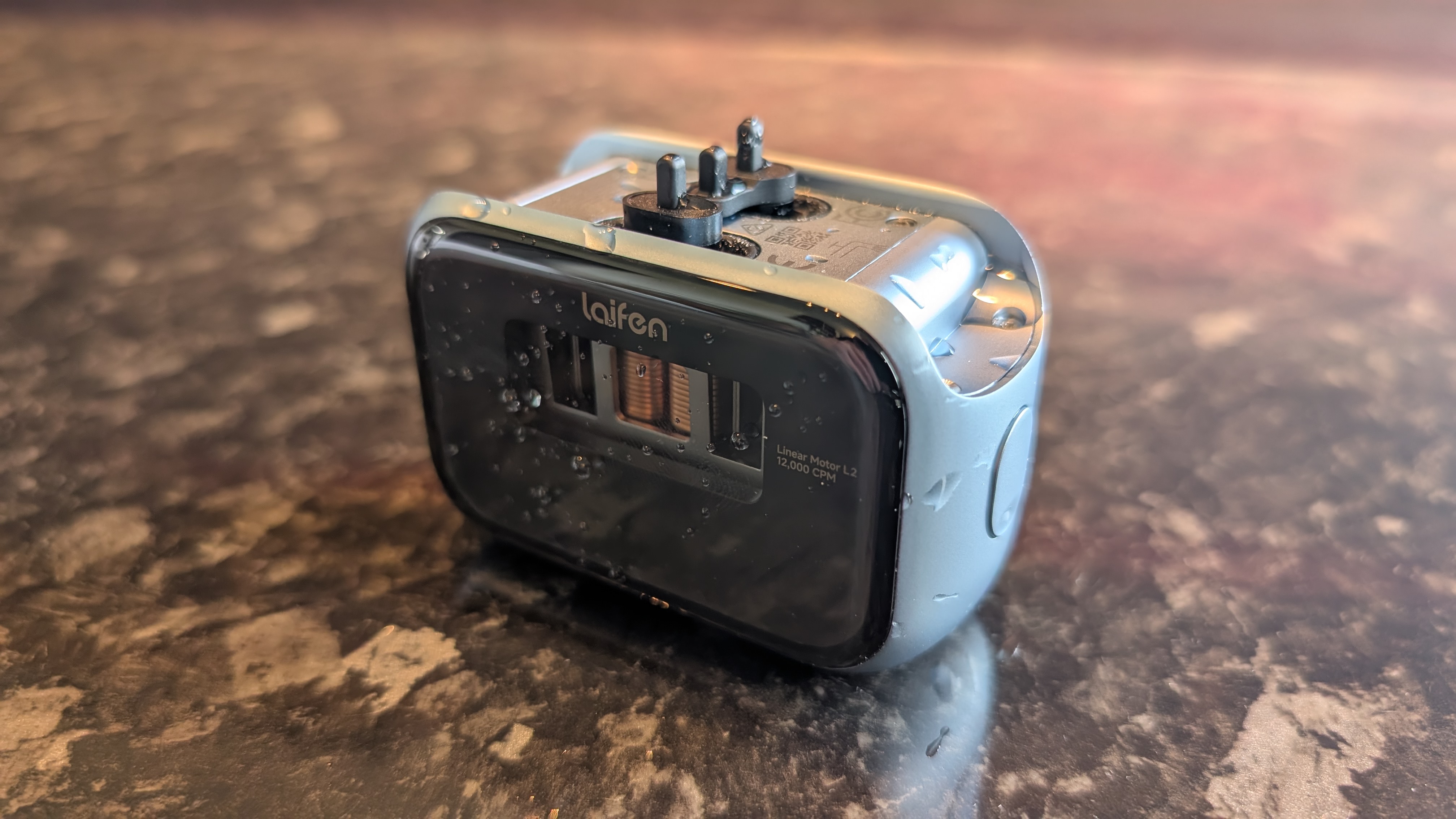 The Laifen P3 Pro electric travel shaver pictured on a dark marble worktop.