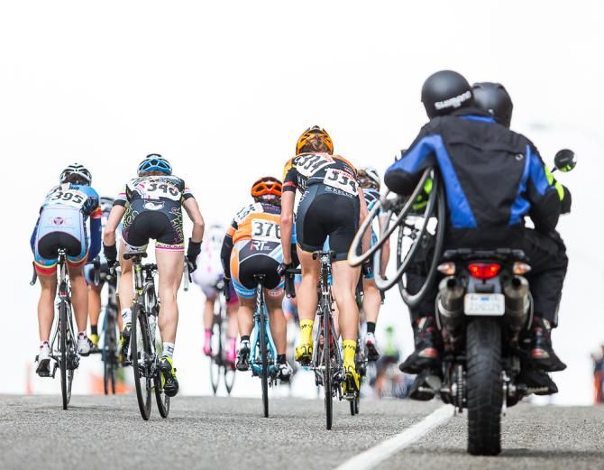 A small group of racers crest the hill