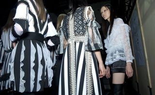 Models wearing black and white striped dress