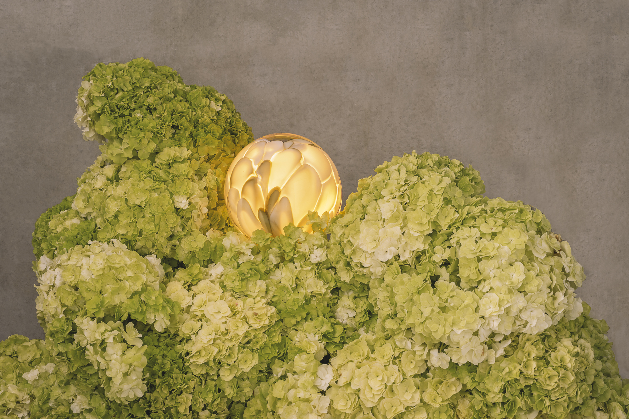 hand-formed glass lamps arranged in floral displays