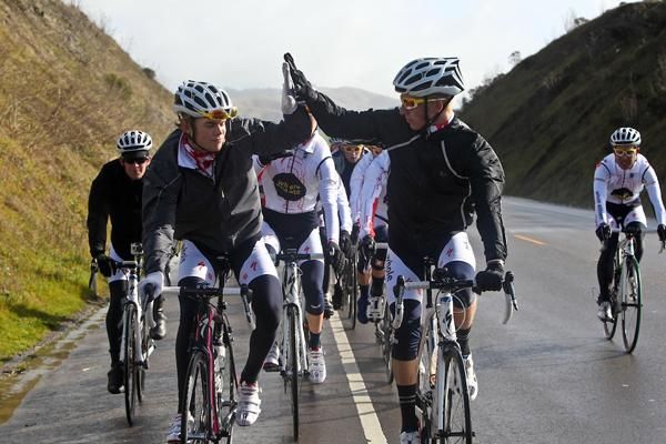 Two riders high five.