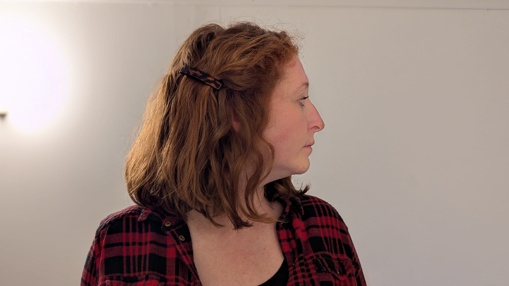 Woman facing forward with her head turned to the left side