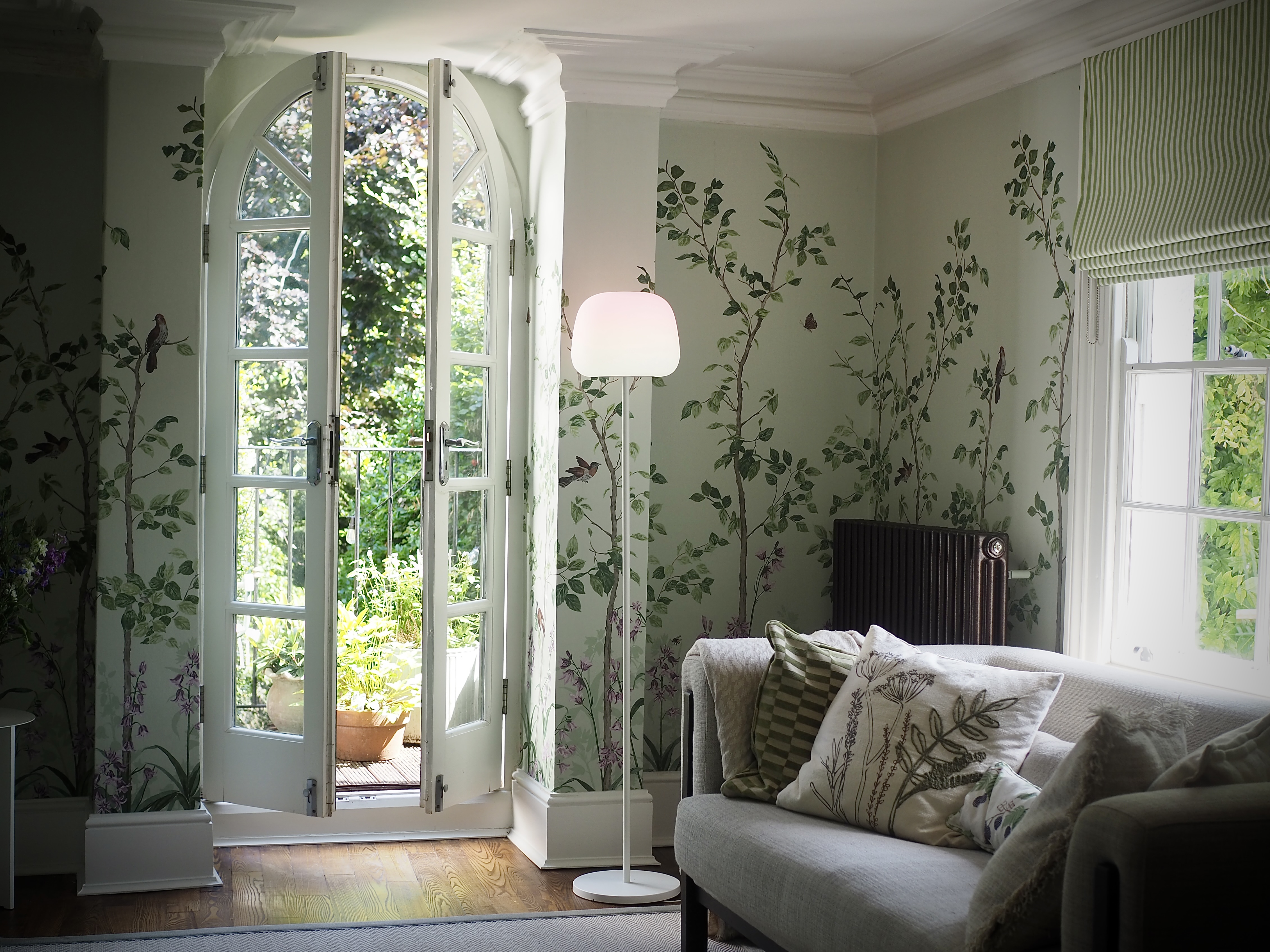The Govee 'Lantern' floor lamp illuminates a botanical mural