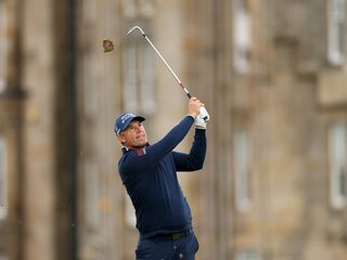 Padraig Harrington after hitting a pitch shot with his divot flying above his head