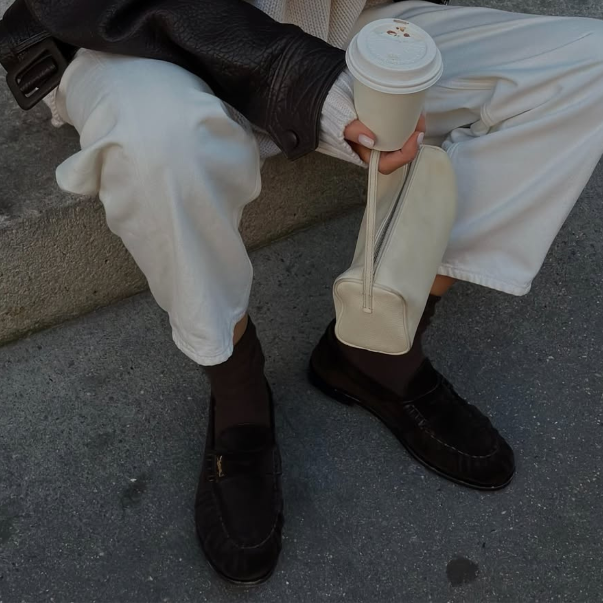 Hannah in brown loafers and white jeans