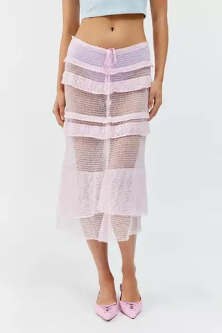 Model is wearing a pink low-rise sheer knit midi skirt