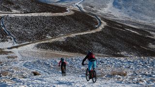 Mountain bikers riding in snow