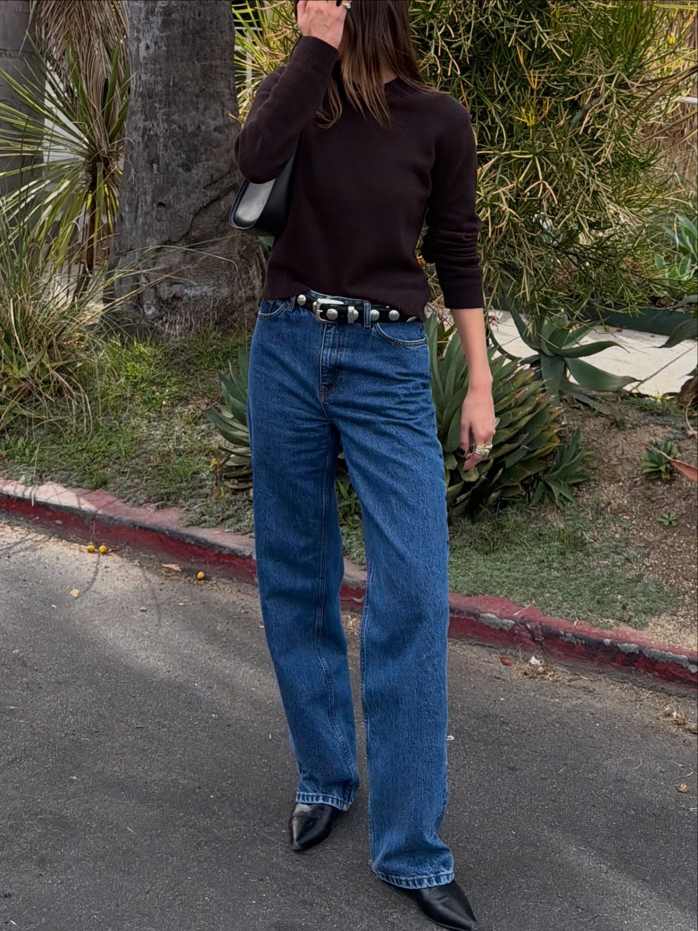 Influencer wearing straight-leg jeans and low-heel ankle boots