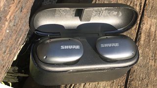 the shure aonic free true wireless earbuds in their charging case