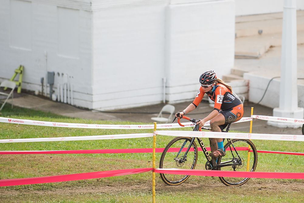 A muddied rider makes her way past the ampatheatre during the final laps of racing. The previous nights rain left the race course tacky muddy for the racers.