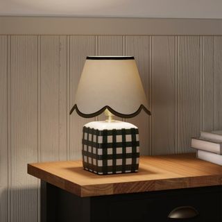 Checked base table lamp shown at night creating a cosy room