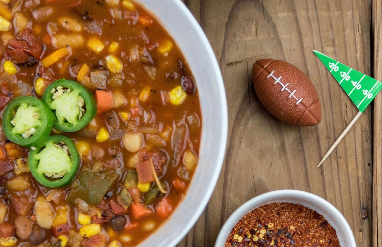 Football Decorations On The Table Next To A Bowl Of A Vegetable Dish