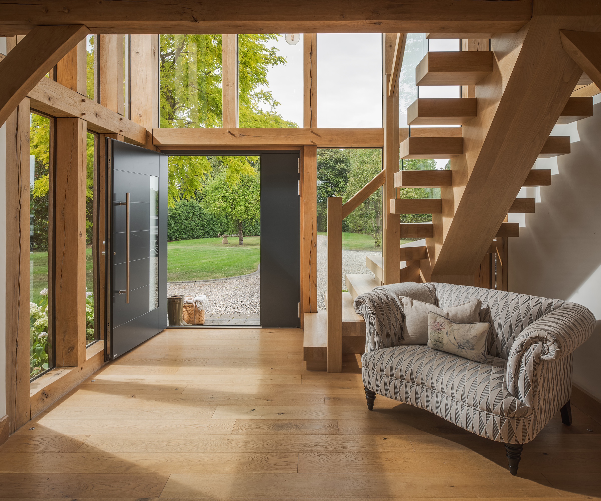 The entrance hall of a double storey self build home with oak frame and impressive glazing
