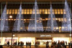 A photo of the front of a John Lewis store with Christmas lights above it