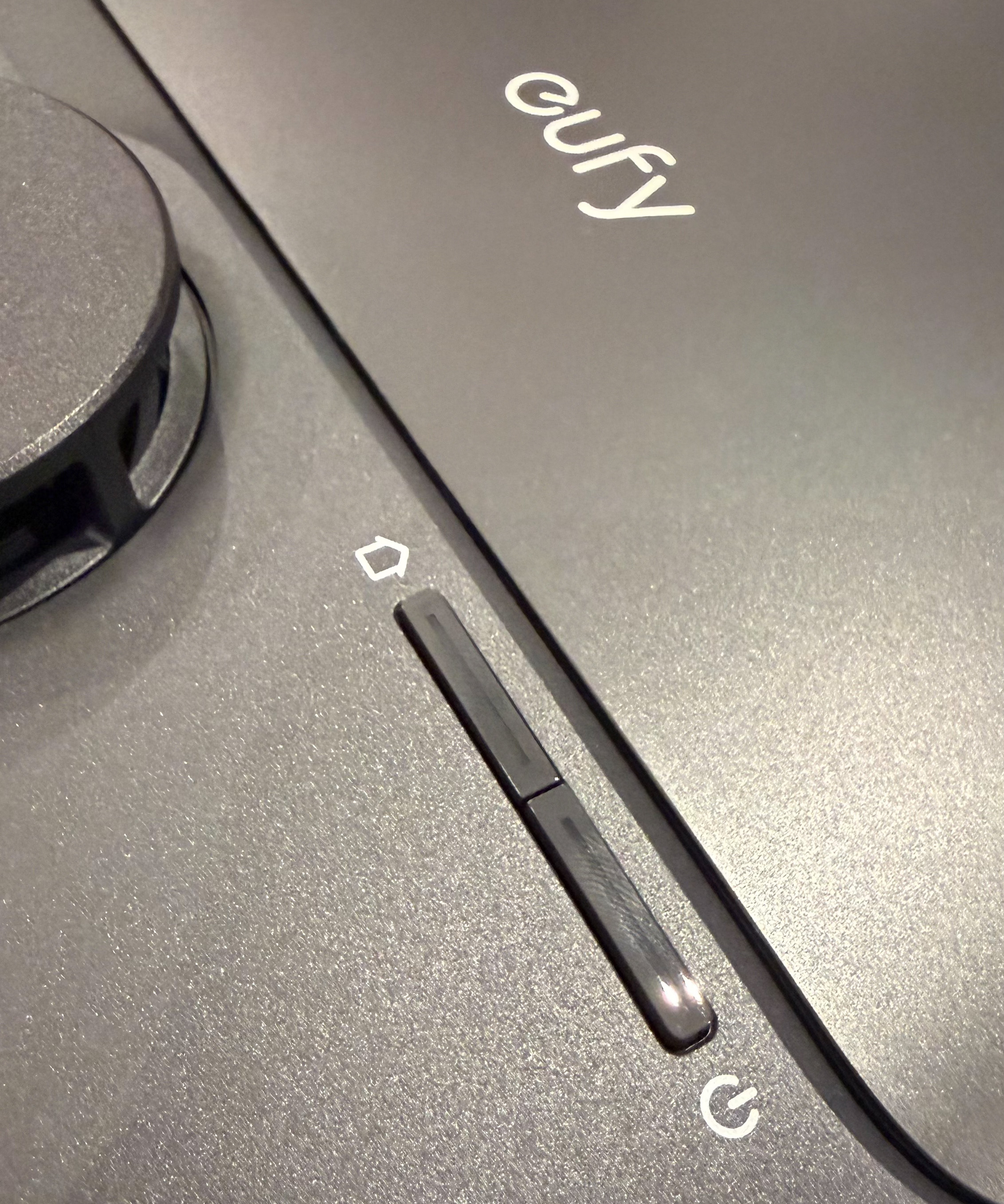 Close-up of eufy Omni C28 physical buttons and control slider on top of robot