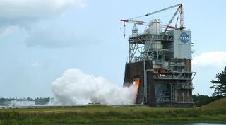 An RS-25 engine performs a static-fire test at NASA's Stennis Space Center Aug. 14. NASA said the test was a success despite ending three minutes early because of a "facility issue."