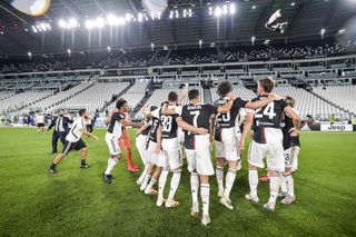 Juventus players celebrate their Serie A title in July 2020 after victory over Sampdoria at an empty Juventus Stadium due to Covid-19 restrictions.