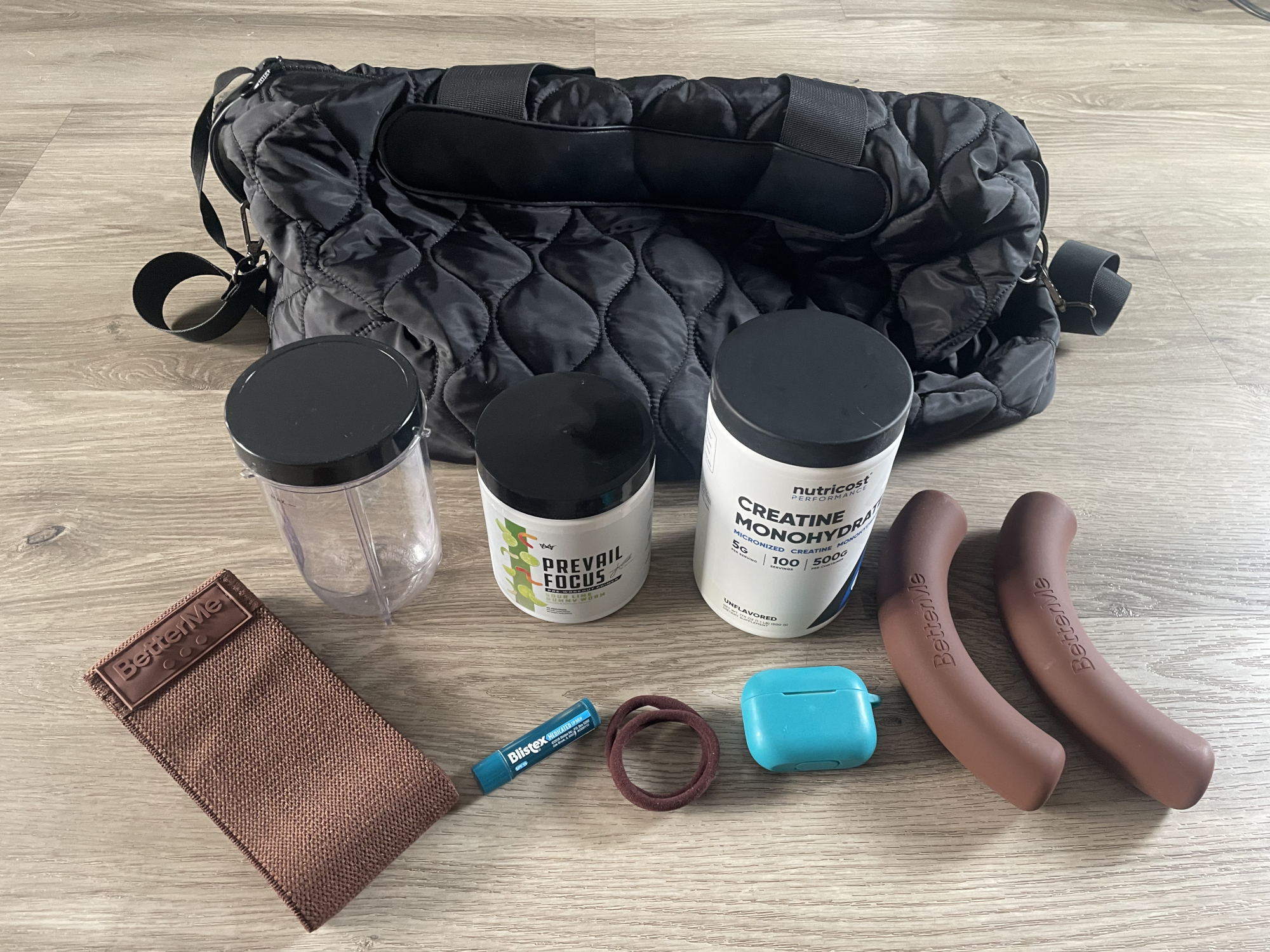 Bag and assorted items on wooden table
