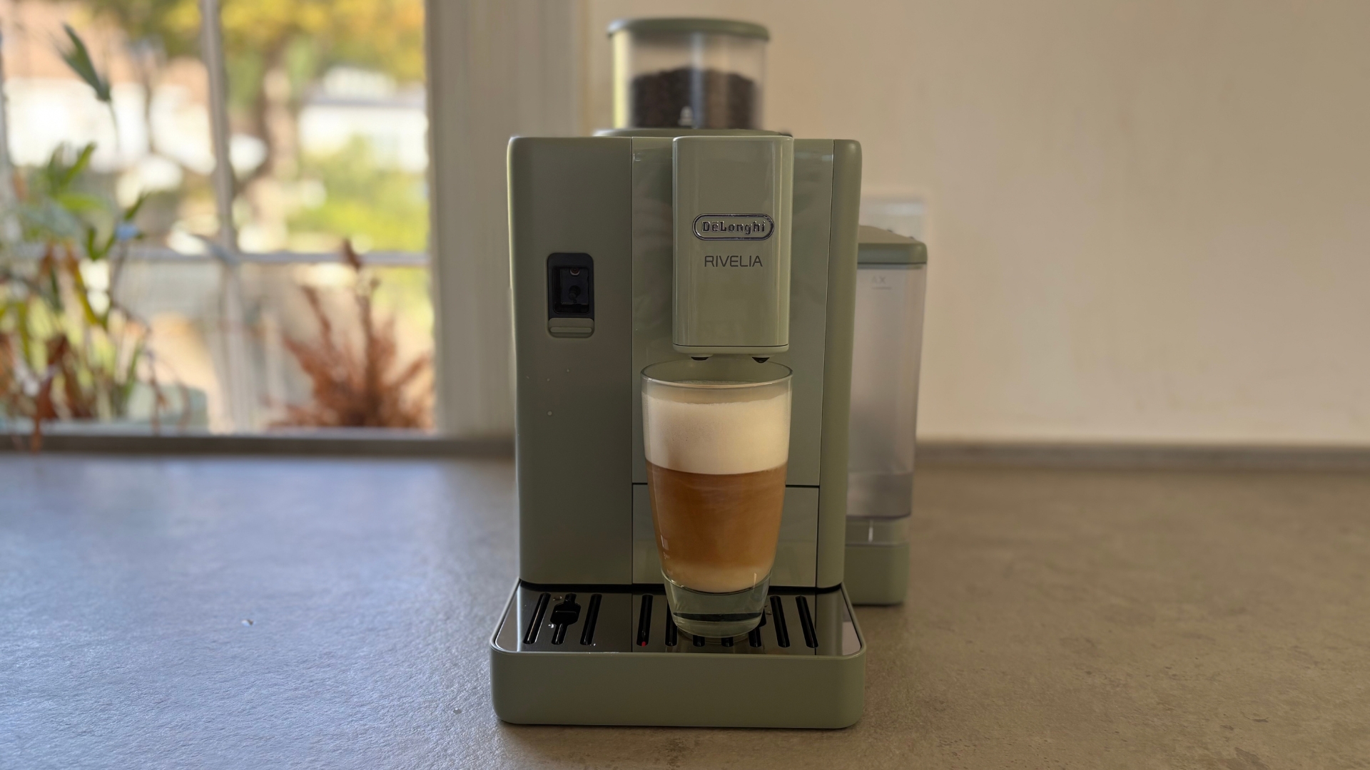De'Longhi Rivelia Start Coffee Machine on the counter making a macchiato