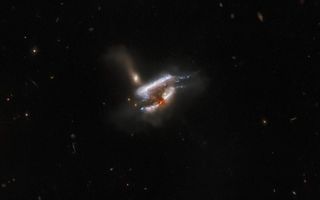Three galaxies collide in this stunning new Hubble Space Telescope image showing the galaxy cluster IC 2431 about 681 million light-years from Earth.