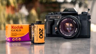 A roll of film in front of a film camera