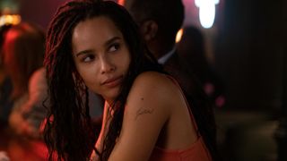 A still from High Fidelity in which Zoë Kravitz leans on a bar.