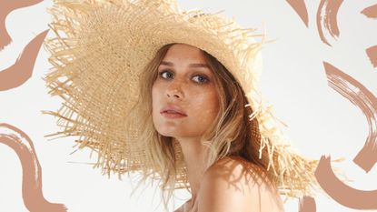 A woman on the beach in a sunhat with golden skin after learning how to apply bronzer