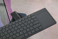 Framework's Wireless Touchpad Keyboard with a keyboard in the bin behind it.
